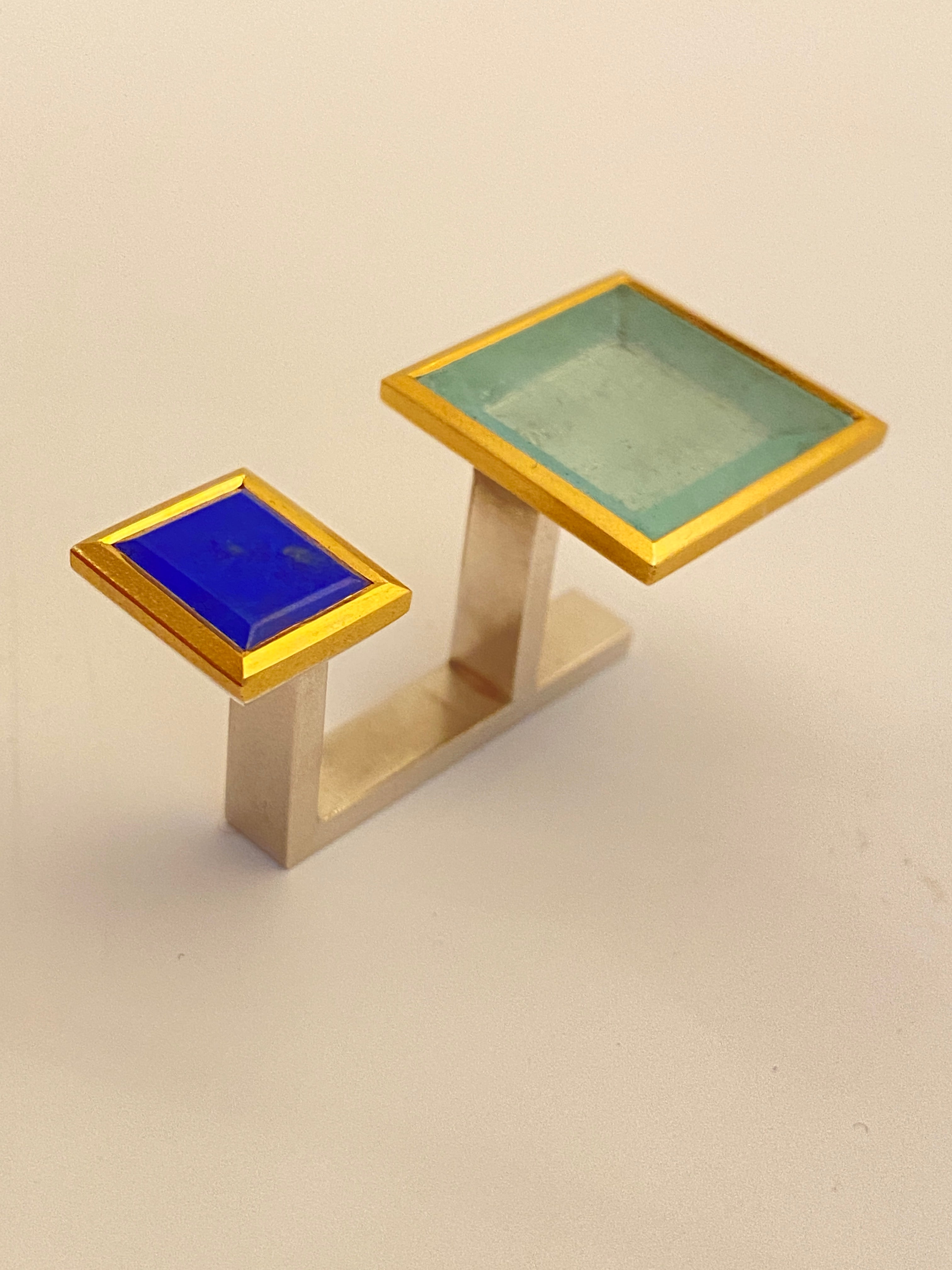 Lamia's two-finger ring Silence is not always golden 1 left side. Made of silver 23k gold lapis and aquamarine