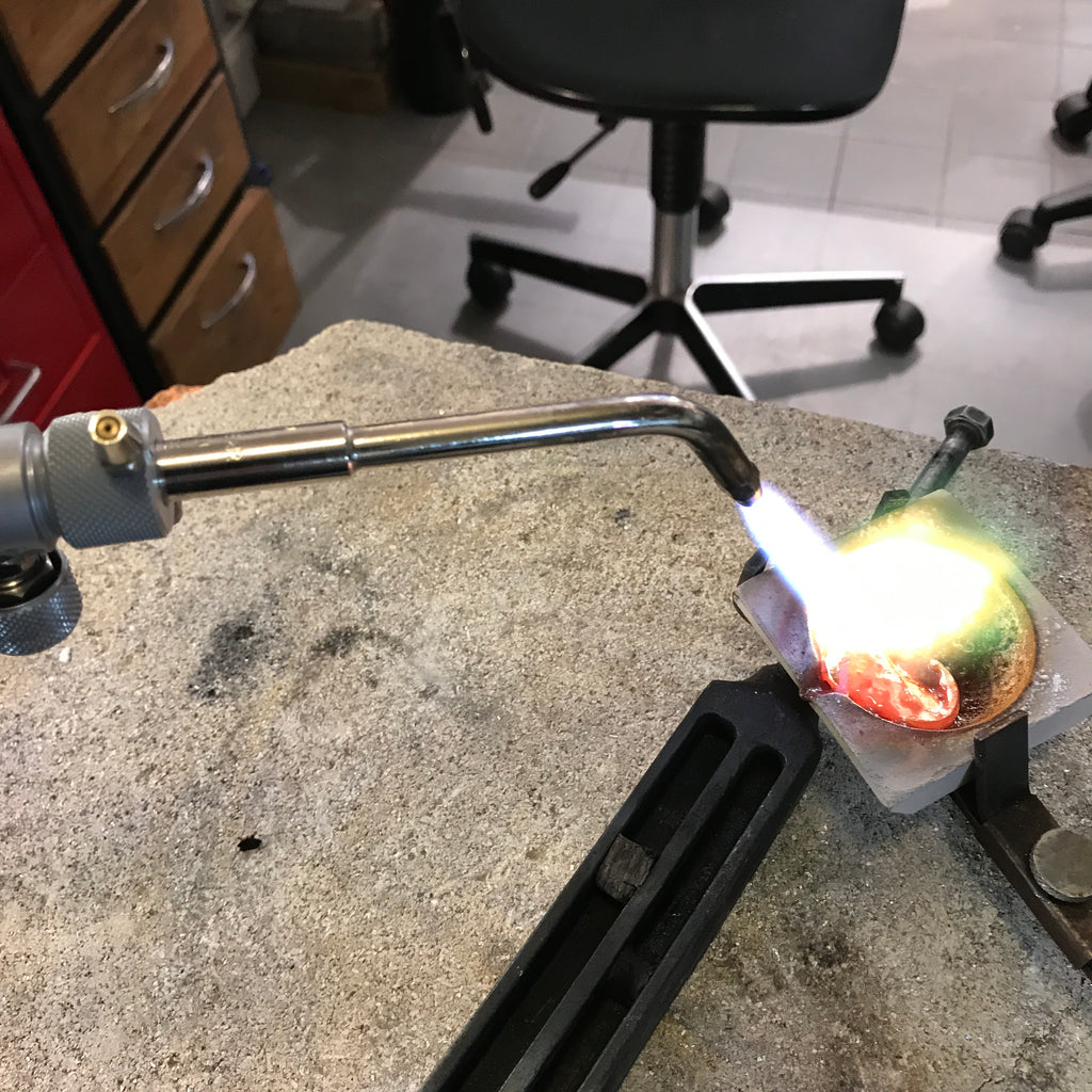 Lamia melting gold in a crucible 