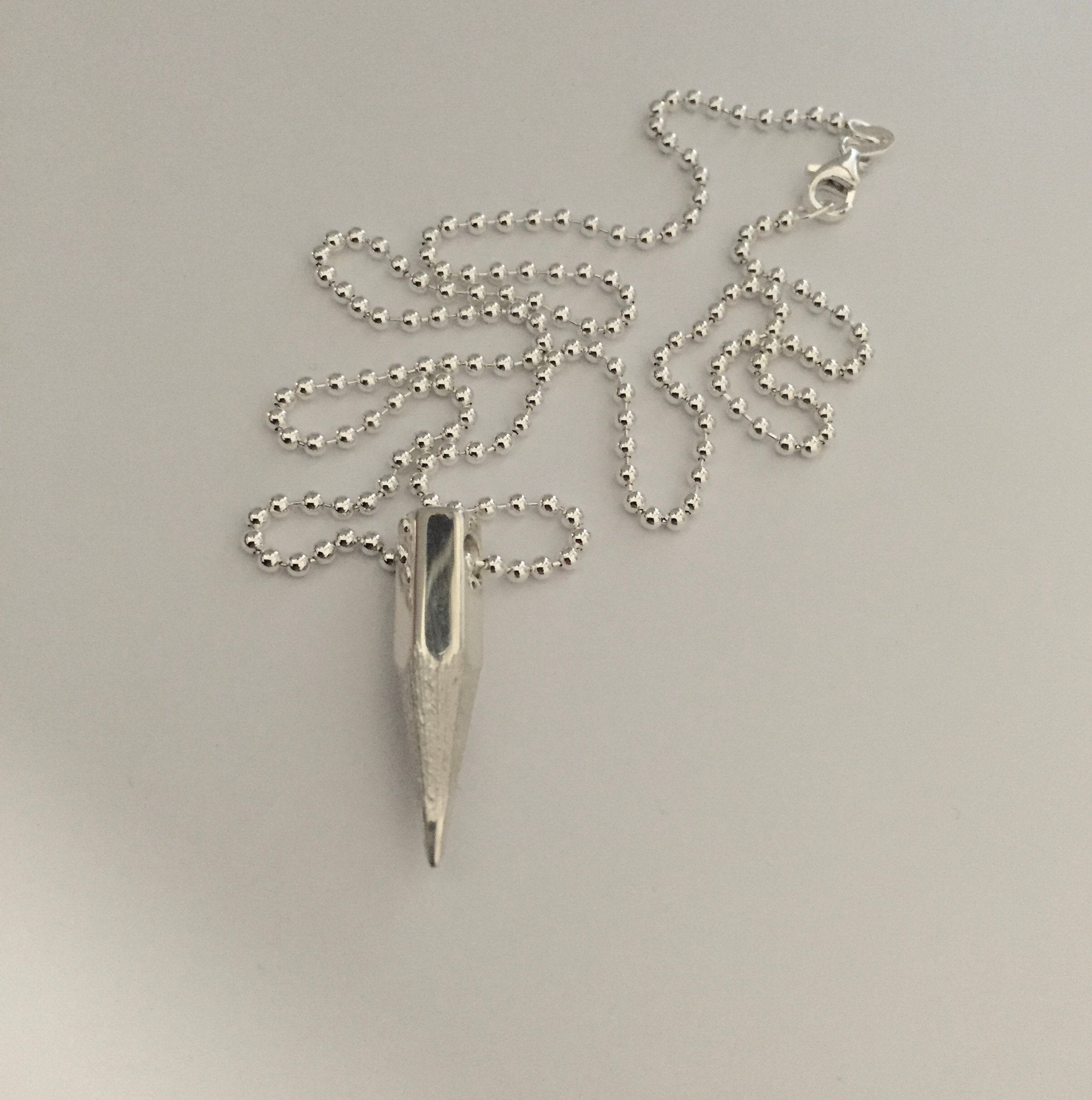 FOUND AT GALLERI PLATINA STOCKHOLM Sharp Words Pendant on a silver chain